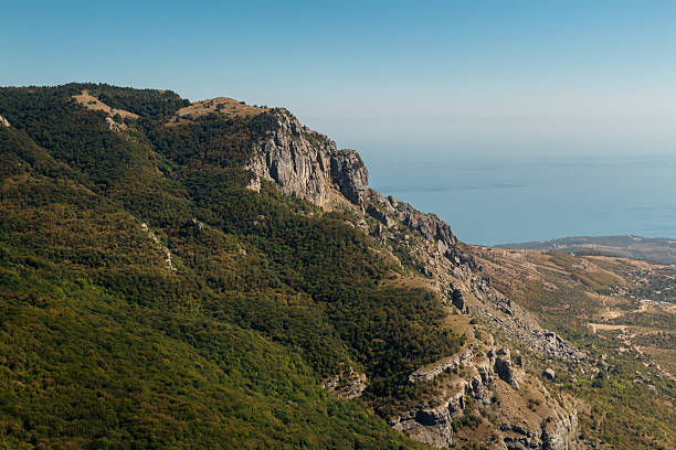 istock Panoramic view from mountain top towards valley and sea 2218081958
