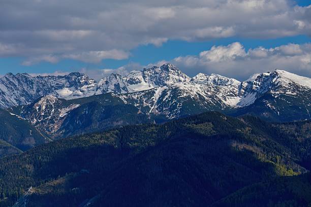 istock Snow-capped mountains stand majestically against a cloudy sky. 2218082663