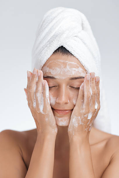 istock Serene Woman Cleansing Face with Foaming Cleanser During Relaxing Skincare Routine 2218091267
