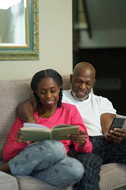 istock Senior Couple Enjoying Relaxing Quality Time Reading and Browsing Together 2218094499