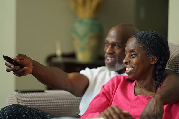istock Smiling Couple Enjoying Quality Time While Watching Television at Home 2218094663