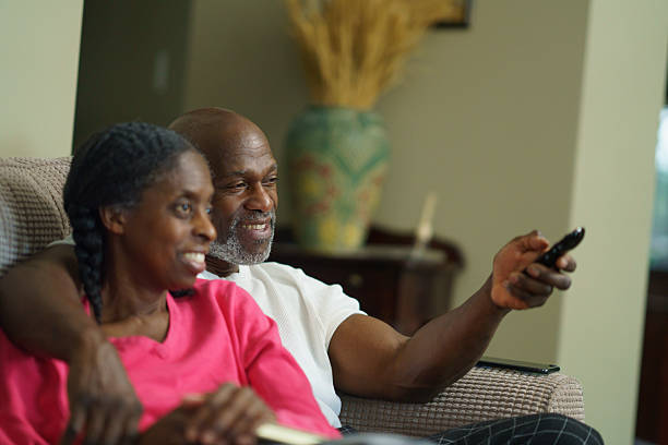 istock Happy Senior Couple Relaxing on Couch and Watching Television 2218094882