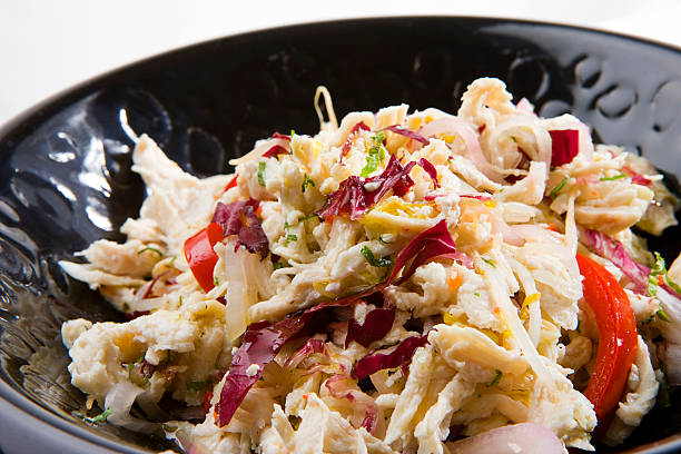 istock Shredded Chicken Salad with Red Cabbage, Onions and Herbs in Black Ceramic Bowl 2218094939