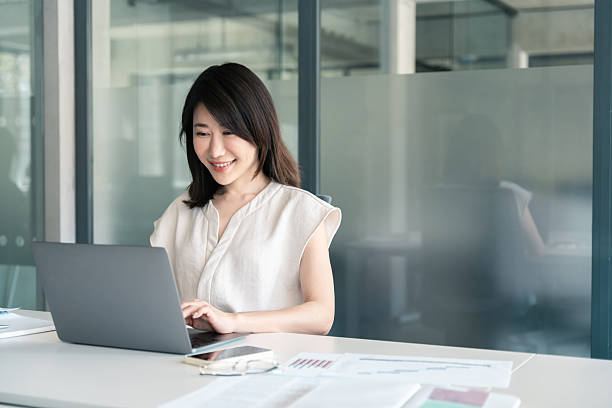 istock 30s middle-aged woman using computer technology app for banker financial work online. Mature Asian professional it specialist businesswoman working on laptop pc sitting at desk in office. Copy space 2218098842