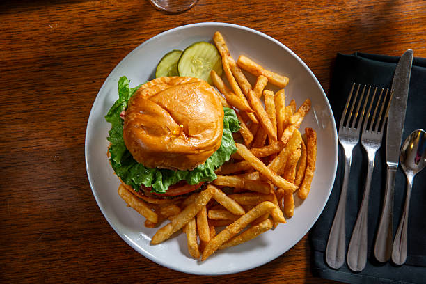 istock Hamburger with fries and pickles 2218098953