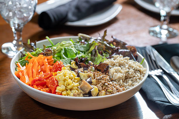 istock Vegan bowl with grains, carrots, spring mix, beans and corn 2218099070