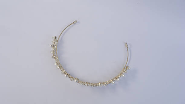 A beautifully crafted silver tiara adorned witha pearl-like beads, showcased on a clean white background.