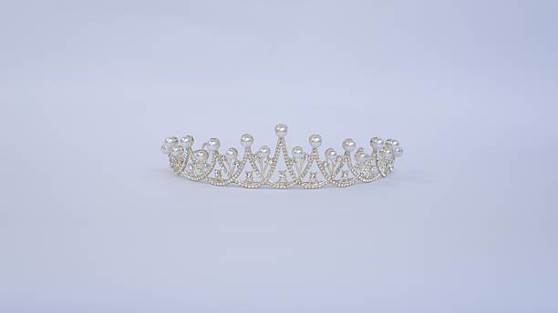 A beautifully crafted silver tiara adorned witha pearl-like beads, showcased on a clean white background.