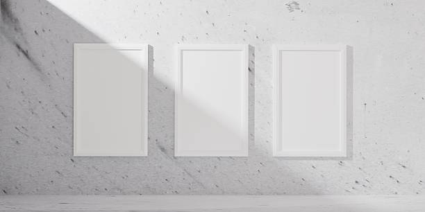 istock 3D render of a minimalist room with three vertical white poster frames on a textured wall. A clean, modern interior perfect for showcasing prints, artwork, or creative displays in a stylish setting. 2218103514