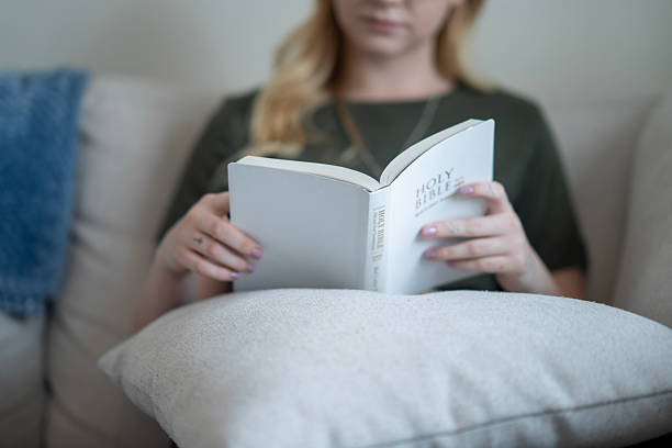 istock Woman Holding and Reading a Holy Bible in a Calm Setting 2218104535