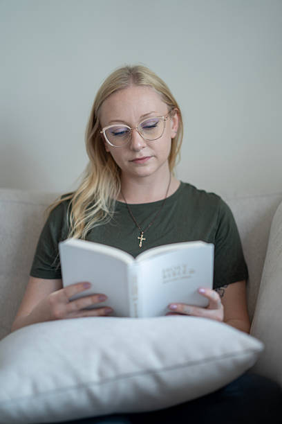 istock Woman Reading a Bible at Home in a Relaxed Setting 2218105012