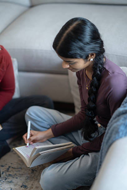 istock Young Woman Engages in Focused Bible Study While Marking Text 2218105471