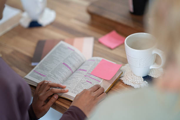 istock Hands Reading a Bible During Study with Highlighters and Coffee 2218106041