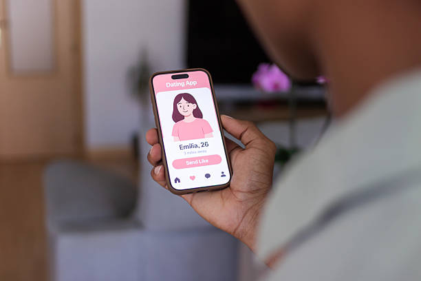 istock Young man using dating app on smartphone at home 2218107096