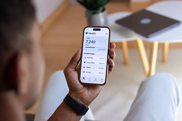istock Man checking health data on smartphone app at home 2218107587