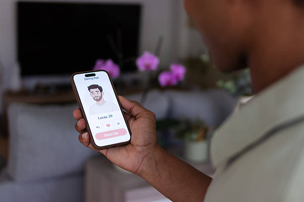 istock Woman holding a smartphone, using a dating app to find a partner 2218108438