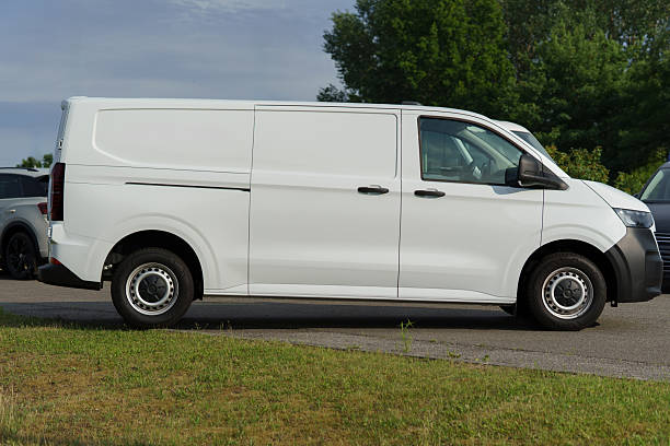 istock White panel van parked with empty space for advertising or company branding 2218109359
