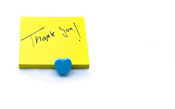 istock Handwritten thank you note on a yellow sticky note with a blue heart, expressing gratitude and appreciation 2218109790