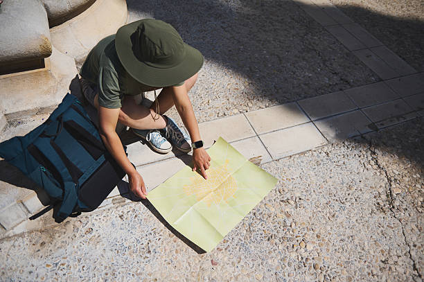 istock Traveler Exploring a Historic Town Street With a Map 2218112725