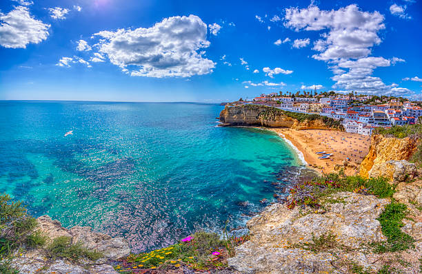 Carvoeiro fishing village with beautiful beach in Algarve, Portugal. View of beach in Carvoeiro town with colorful houses on coast of Portugal. Praia de Carvoeiro in Algarve beautiful beach in carvoeiro algarve portugal stock pictures, royalty-free photos & images