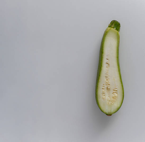 istock A zucchini cut in half, showing its inner structure and texture. 2218113801