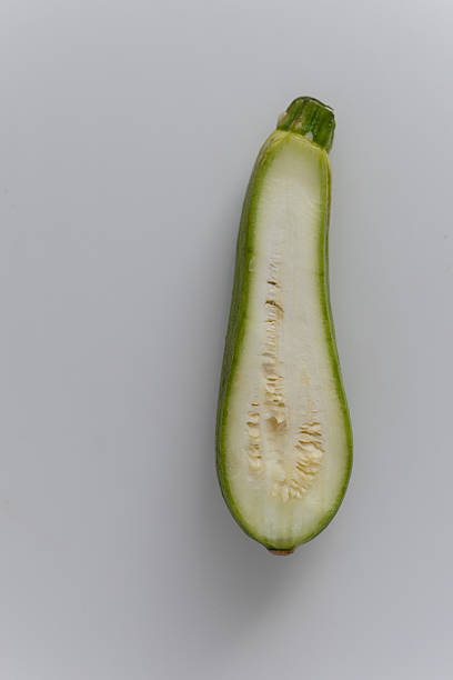 istock A zucchini cut in half, showing its inner structure and texture. 2218113806