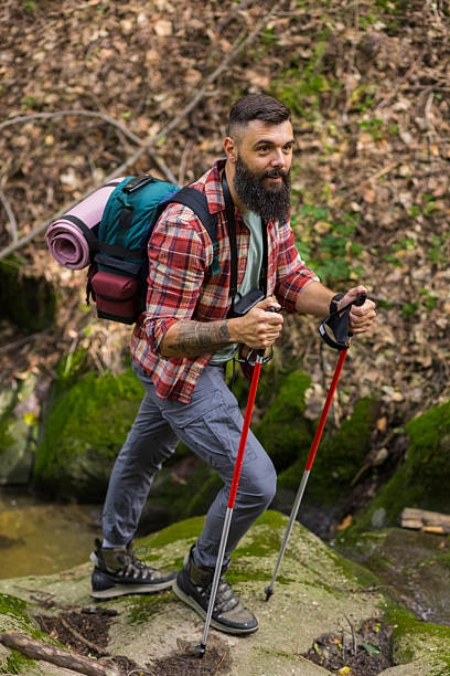 istock Bearded Hiker Smiles Amid Forest Stream Adventure 2218118464