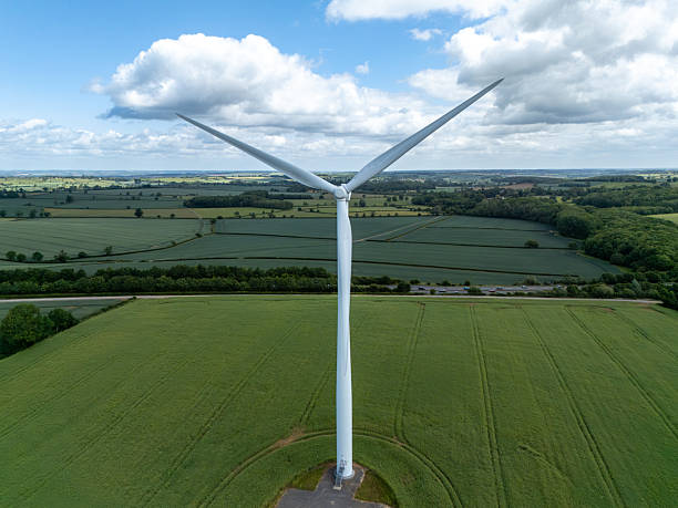 istock Wind turbine dominating the green landscape under a cloudy sky 2218121823