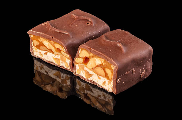 istock Brown chocolate bar in section on black background 2218123388