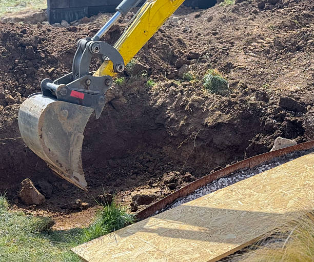 istock Close up view of excavator bucket digging ground on construction site 2218125288