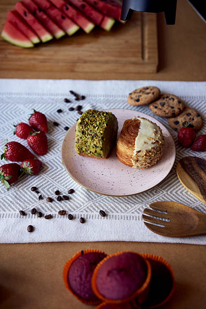 Delicious pastries with pistachio and hazelnut topping served on a pink plate
