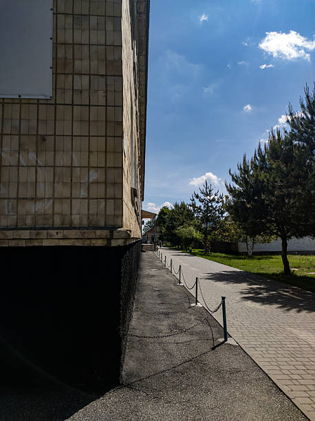 istock A sidewalk next to a building with a chain link fence 2218126353