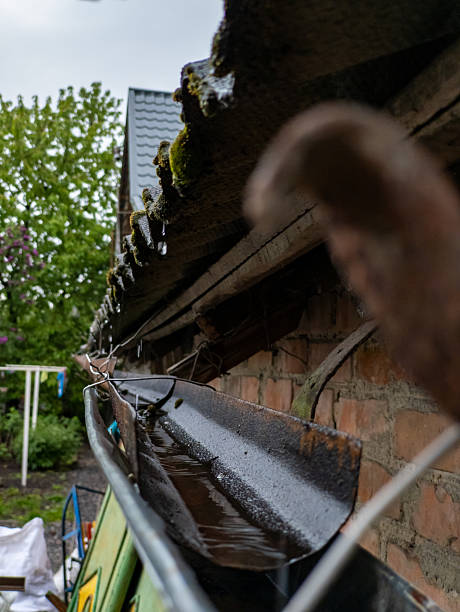 istock A rusty metal gutter on the side of a brick building 2218128295