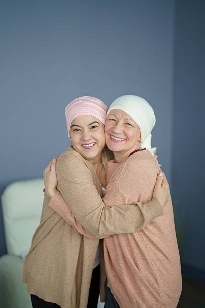 istock Women Embracing Each Other While Smiling in Supportive and Caring Moment 2218130814