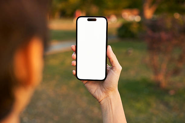 istock Young woman showing mobile phone blank white screen on Summer Background 2218131109