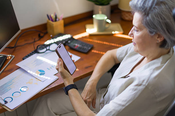 istock Businesswoman working from home using smartphone and computer 2218131902