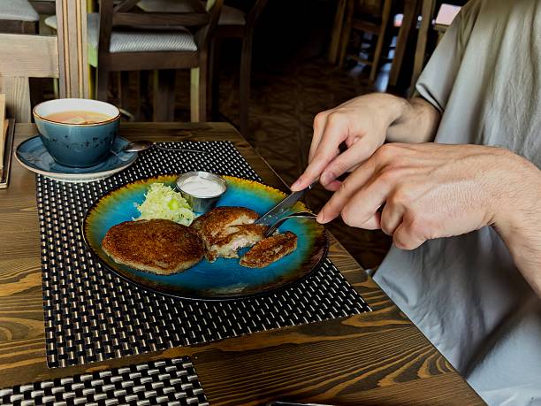 Tea, cup, hands, potato pancakes, dinner, cuts, knife, salad, man, guy, tea party, saucer, spoon, breakfast, lunch, food, drink, hot, cafe, coffee shop, for website, for blog, for video, for visual, beautiful, aesthetics, play of light
