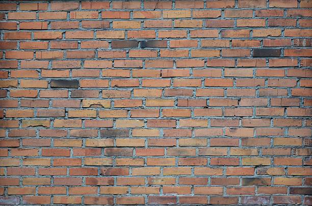 Wall background of old red bricks. Red brick wall background. Red blocks wall closeup.