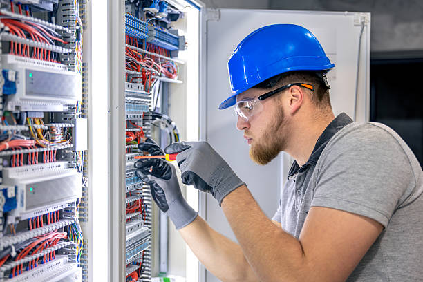 istock Male electrician in uniform working in a switchboard. Electricity. 2218139896