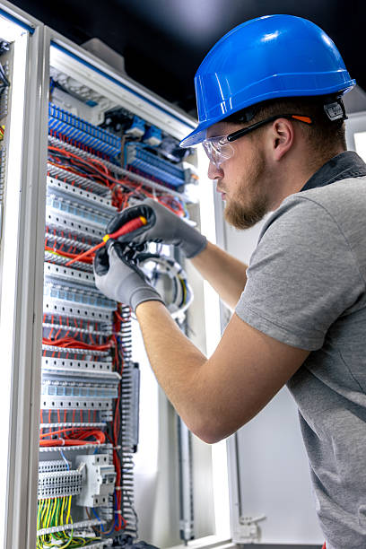 istock Male electrician in uniform working in a switchboard. Electricity. 2218139898
