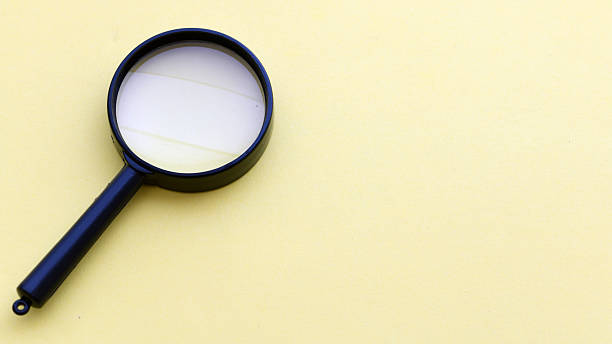 istock Black magnifier on a yellow background. 2218141137