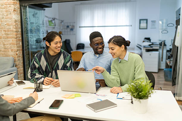 istock Young multi-ethnic businesspeople collaborating on a project using laptop in the office 2218141837