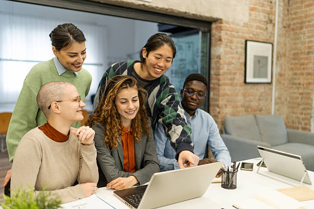 istock Young professionals collaborating on laptop in modern office 2218142043