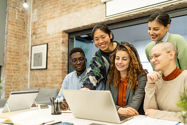 istock Young professionals collaborating on laptop in modern office 2218142045