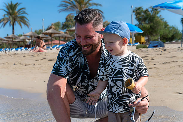 istock Father and son wearing matching outfits enjoying beach vacation 2218143040