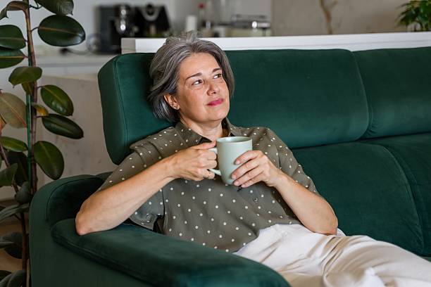 istock Senior woman relaxing on sofa 2218145007