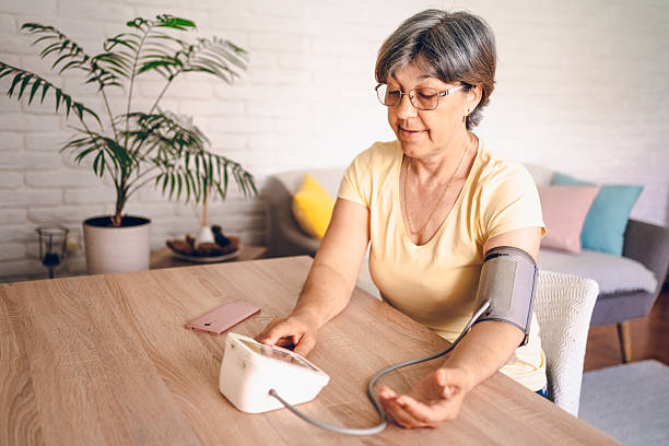 istock Woman check blood pressure measure device on hand 2218145291