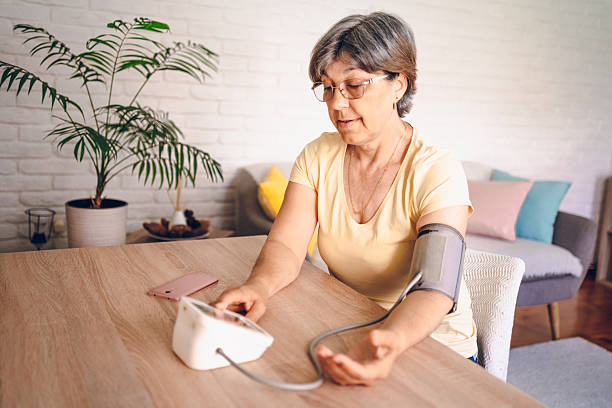 istock Woman check blood pressure measure device on hand 2218145481