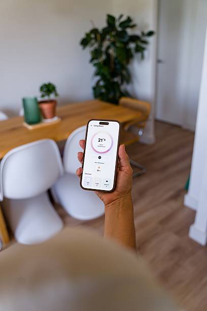 istock Woman controlling home temperature with a smart home app 2218146174