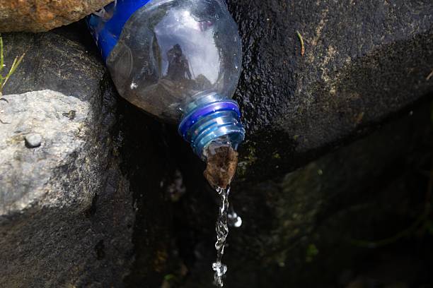 water coming out of a clear plastic bottle with a blue label